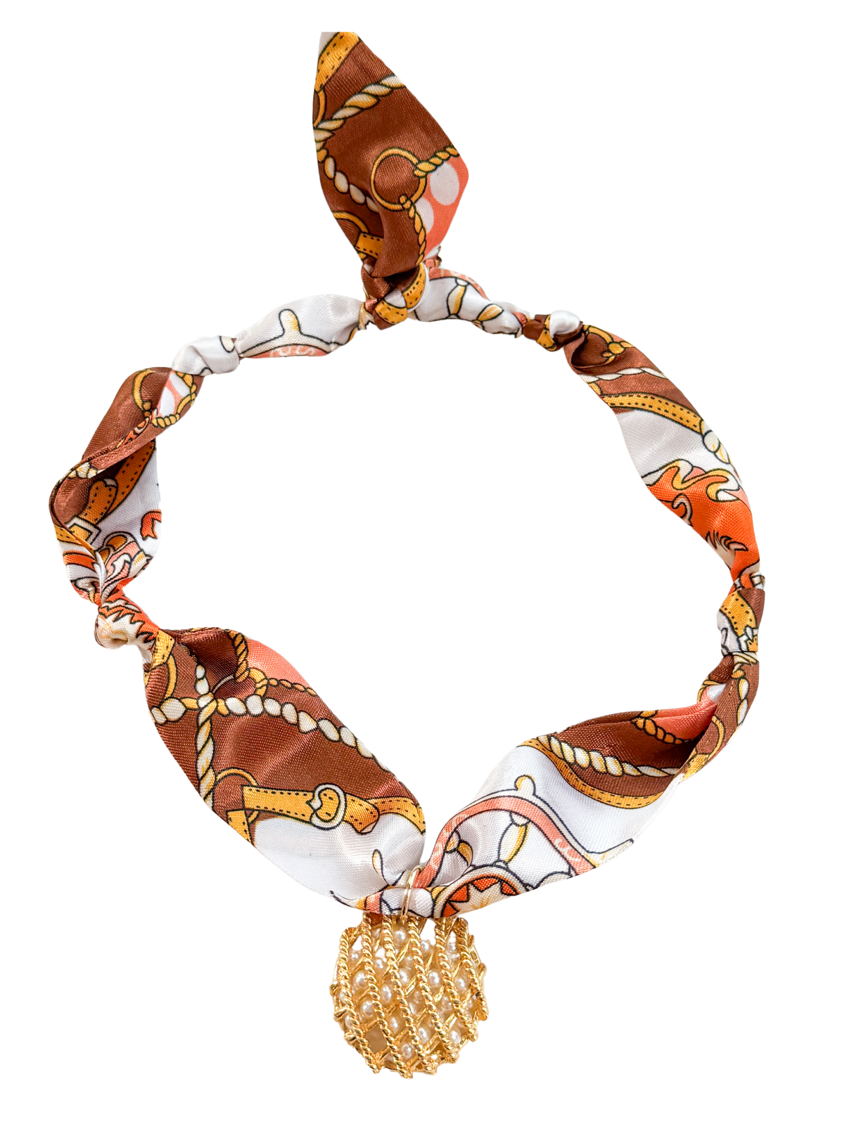 The Bergamo Scarf Necklace by Kinsey Designs features a brown, orange, and gold pattern with a hand-selected gold pendant at the center.