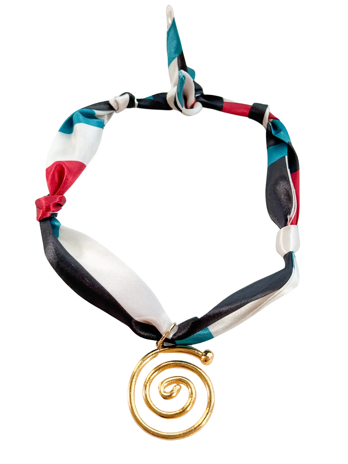 The Bologna Scarf Necklace by Kinsey Designs is a vibrant vintage-inspired accessory with a gold spiral pendant, knot detail, and adjustable scarf design.