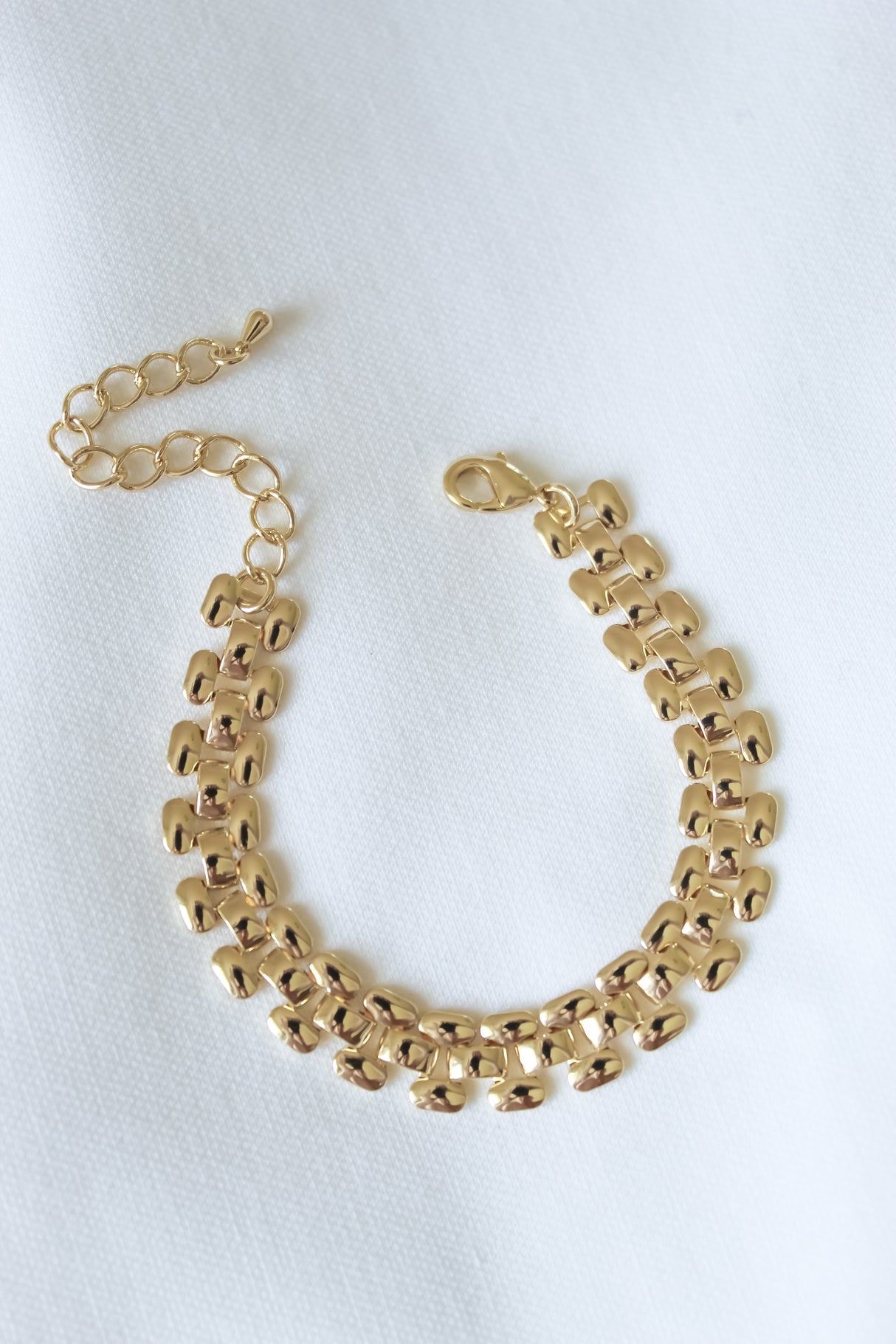 The Basque Bracelet by Kinsey Designs Collection features gold-filled rectangular links and a lobster clasp. This 6" exclusive sample sale piece is displayed on white textured fabric.