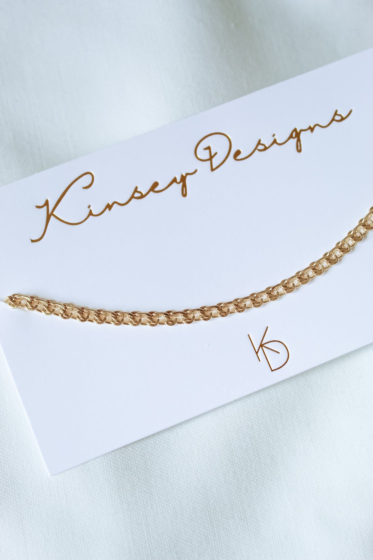 Gabi Necklace by Kinsey Designs Archives displayed on a white card with gold lettering—part of our exclusive sample sale.
