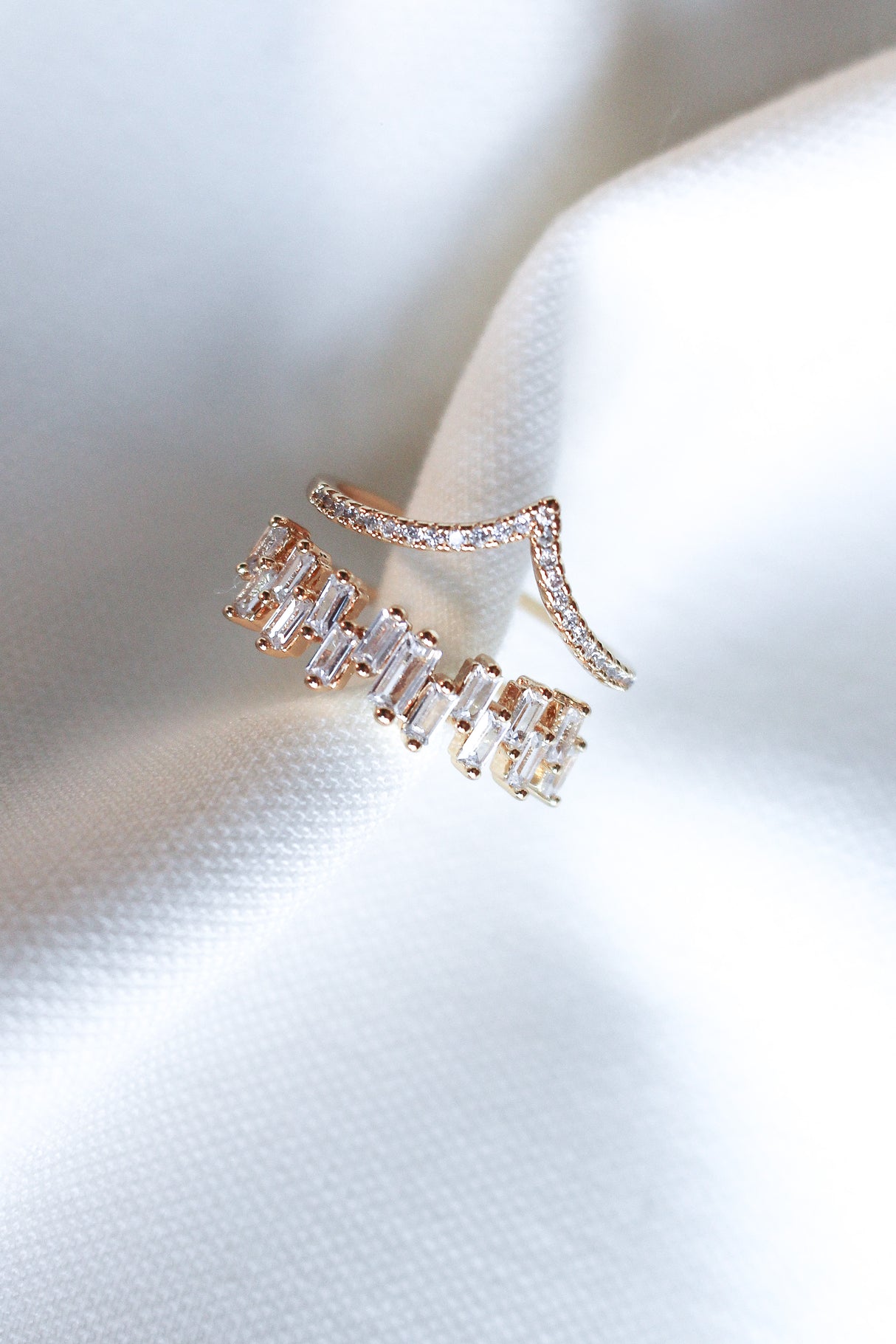 The Ines Ring by Kinsey Designs features gold plating with rectangular and round cubic zirconia stones, displayed on white textured fabric.