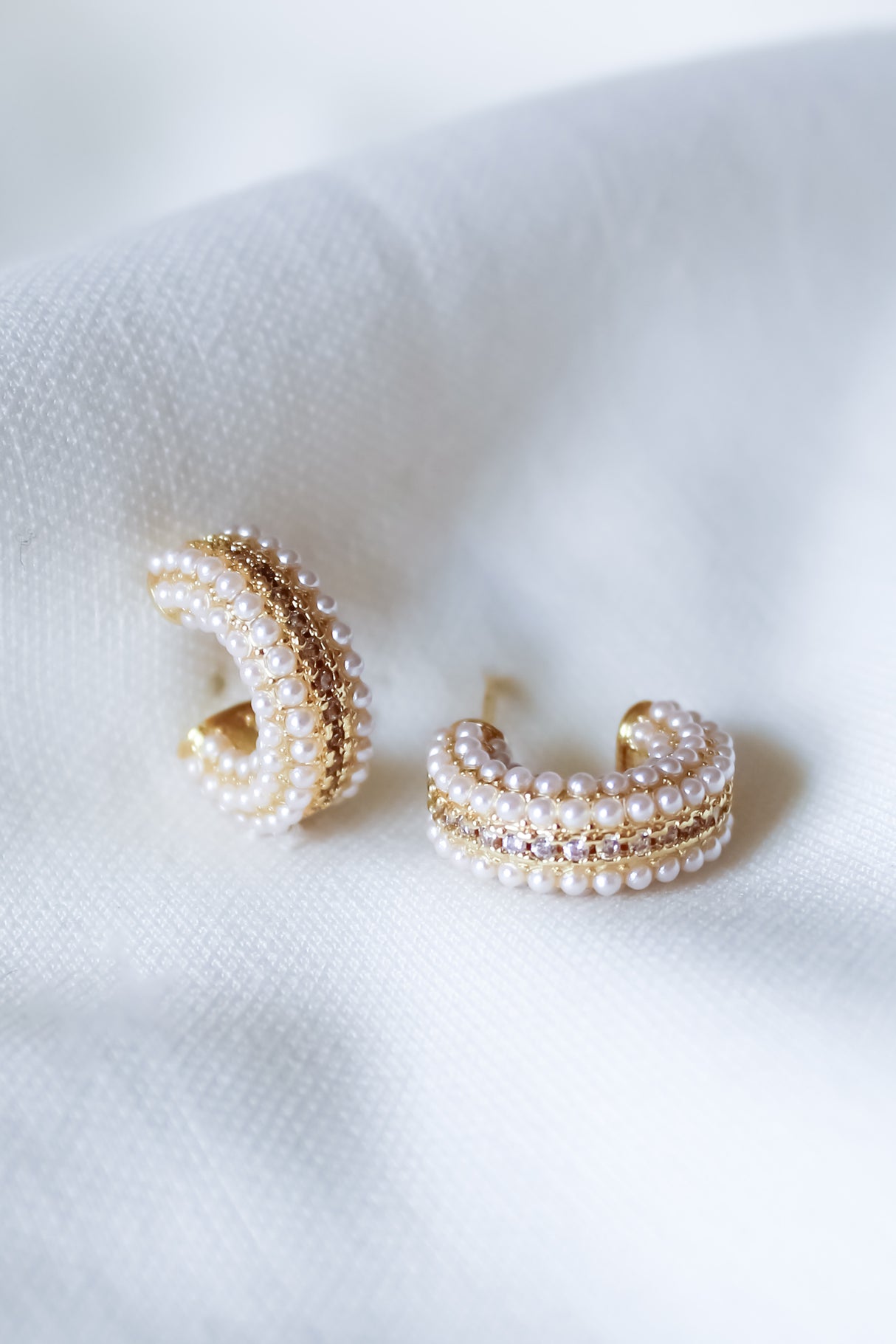 The Korey Pearl Hoops by Kinsey Designs feature lustrous pearls set on elegant gold-filled hoops for a classic look.
