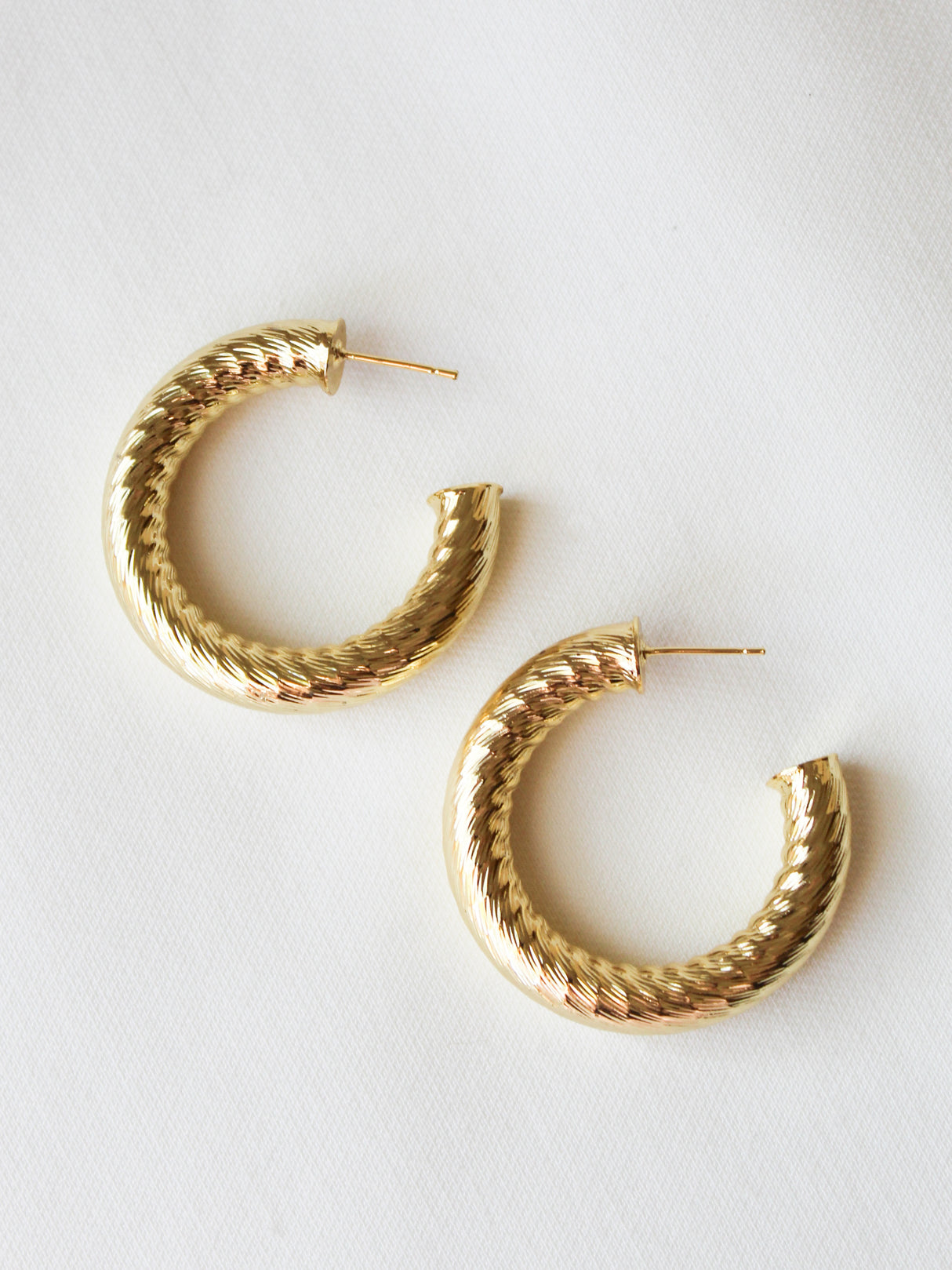 The Kinsey Designs Ladrielle Hoop earrings are textured gold filled hoops displayed on a white background.
