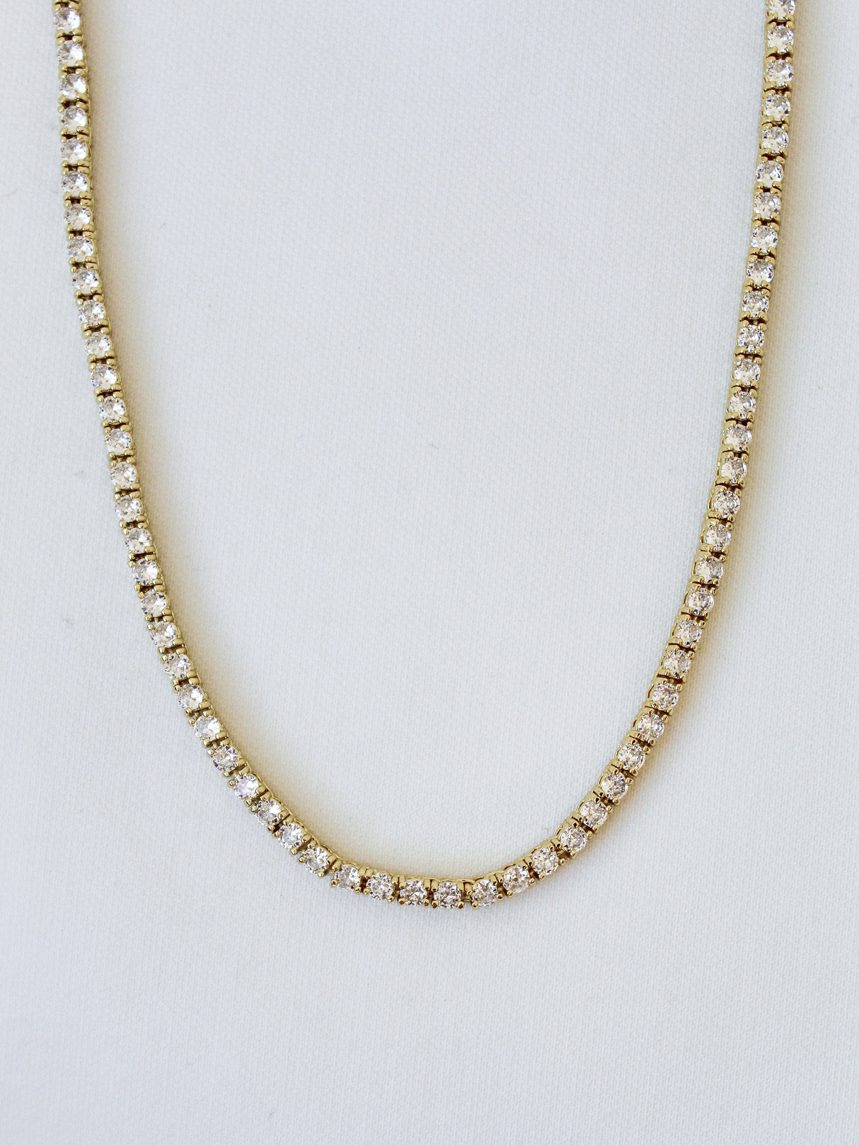 The Malia Tennis Necklace by Kinsey Designs Archives features round diamonds and a 15" gold filled chain, shown on a white background. Don’t miss your chance to own this classic piece at our exclusive sample sale.