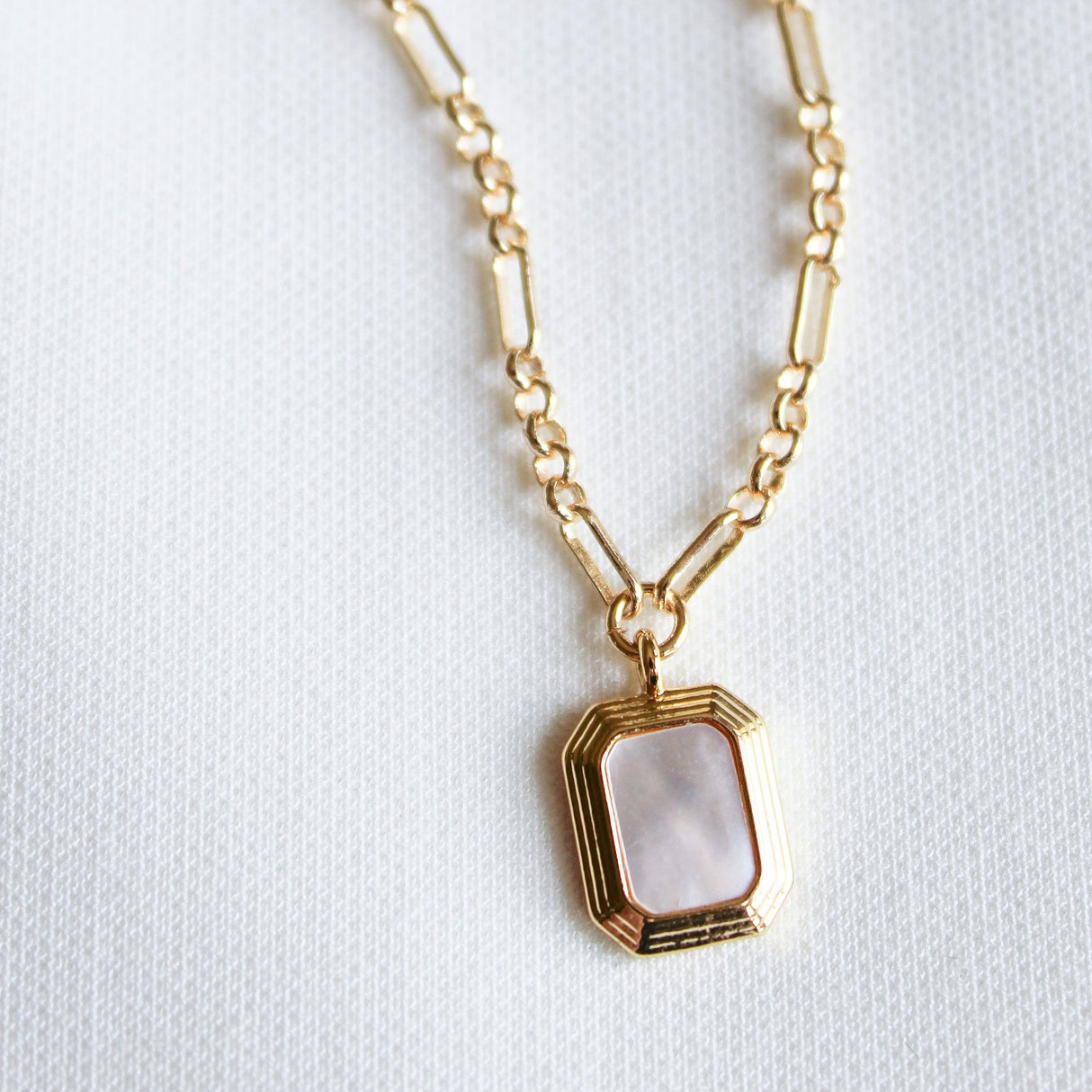 The Mirabelle Pendant Necklace by Kinsey Designs Archives features a rectangular mother-of-pearl pendant on a classic 20" gold filled chain, displayed against a white textured background.