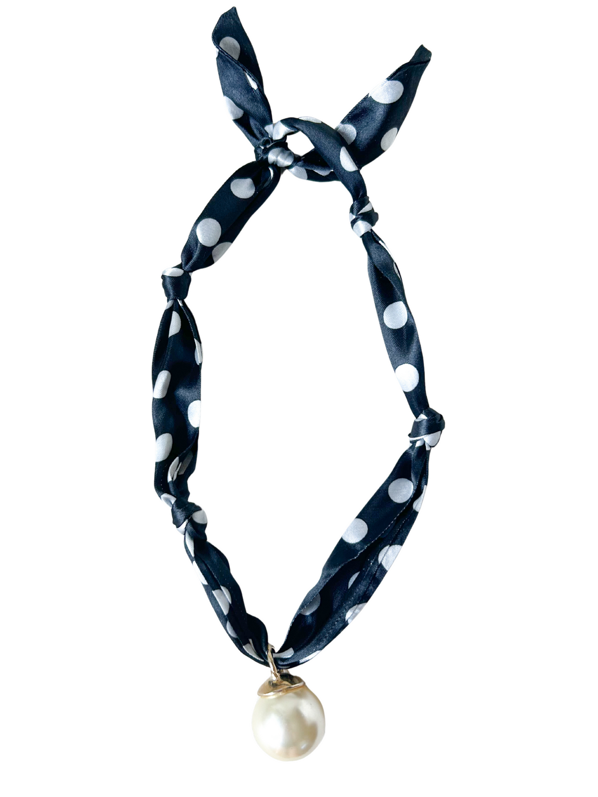 The Otranto Scarf Necklace by Kinsey Designs Archives features a navy blue polka dot scarf and a large white pearl pendant, combining vintage charm with modern style.