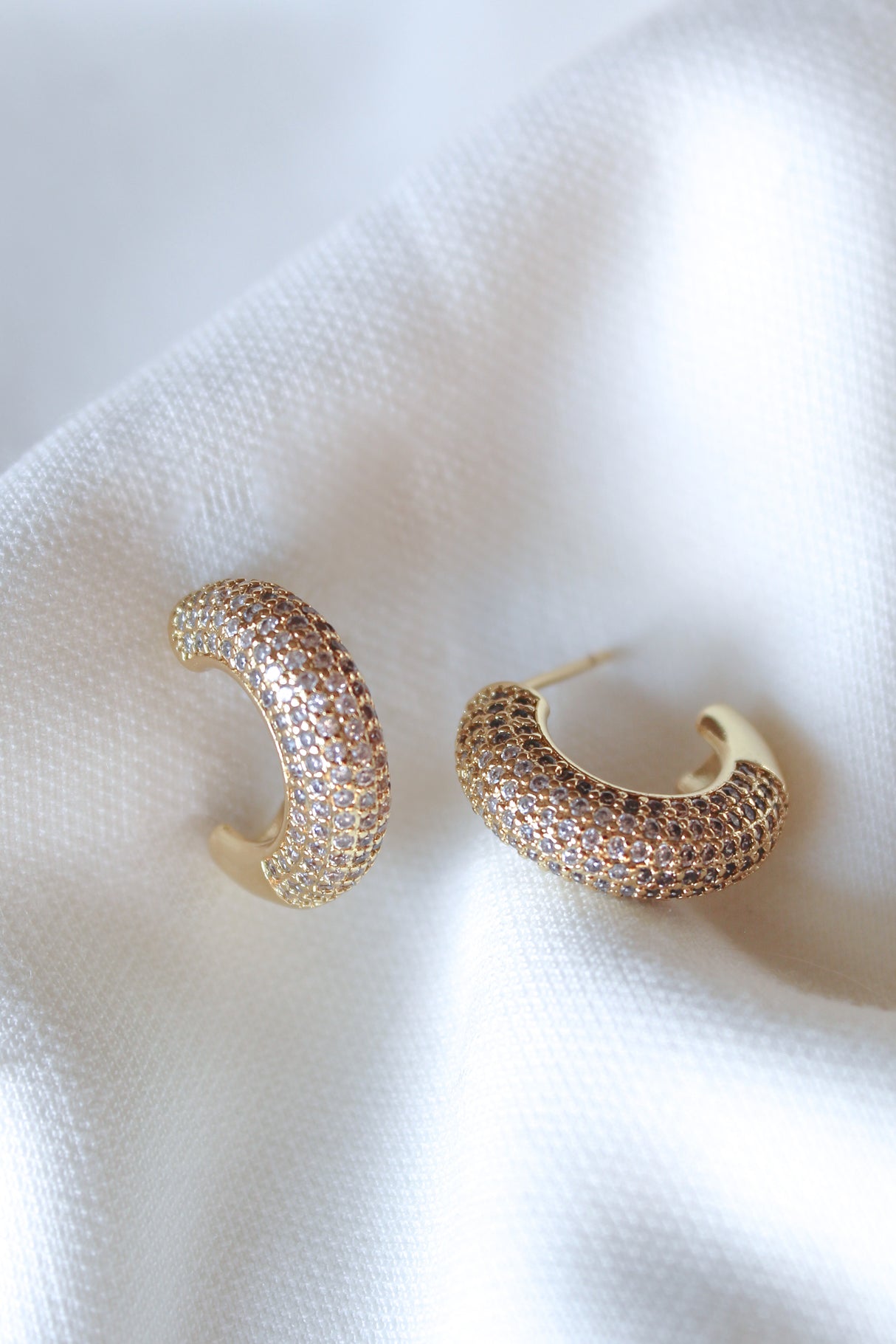 The Sax Hoop by Kinsey Designs: gold filled hoop earrings with small sparkling stones, .85" diameter, displayed on soft white fabric.
