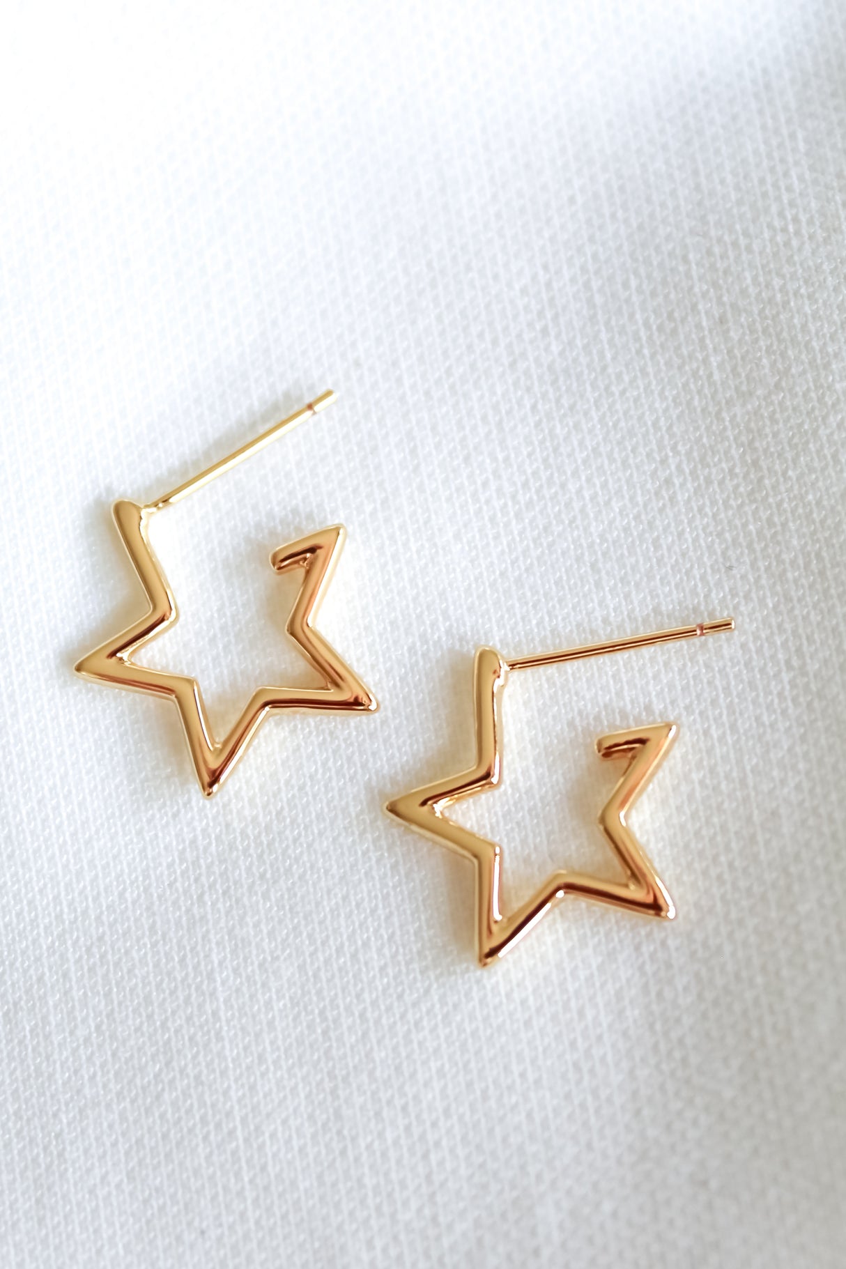 The Kinsey Designs Archives Superstar Earring features gold-filled star-shaped hoops, each with a 0.5" diameter, shown on a white textured fabric background.