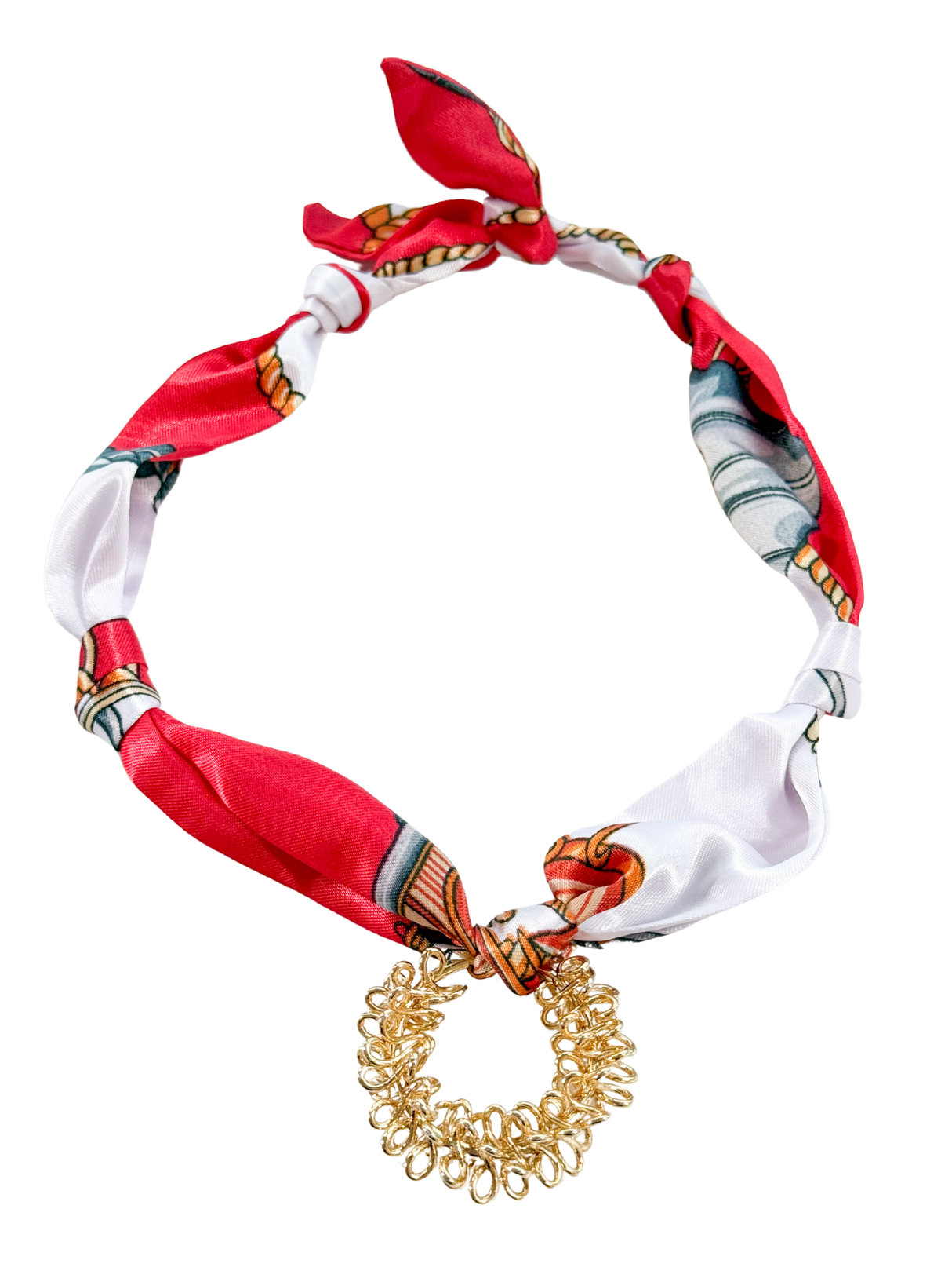 The Taranto Scarf Necklace by Kinsey Designs features a red and white patterned fabric band with an elegant gold looped pendant. This adjustable accessory adds sophistication to any outfit.