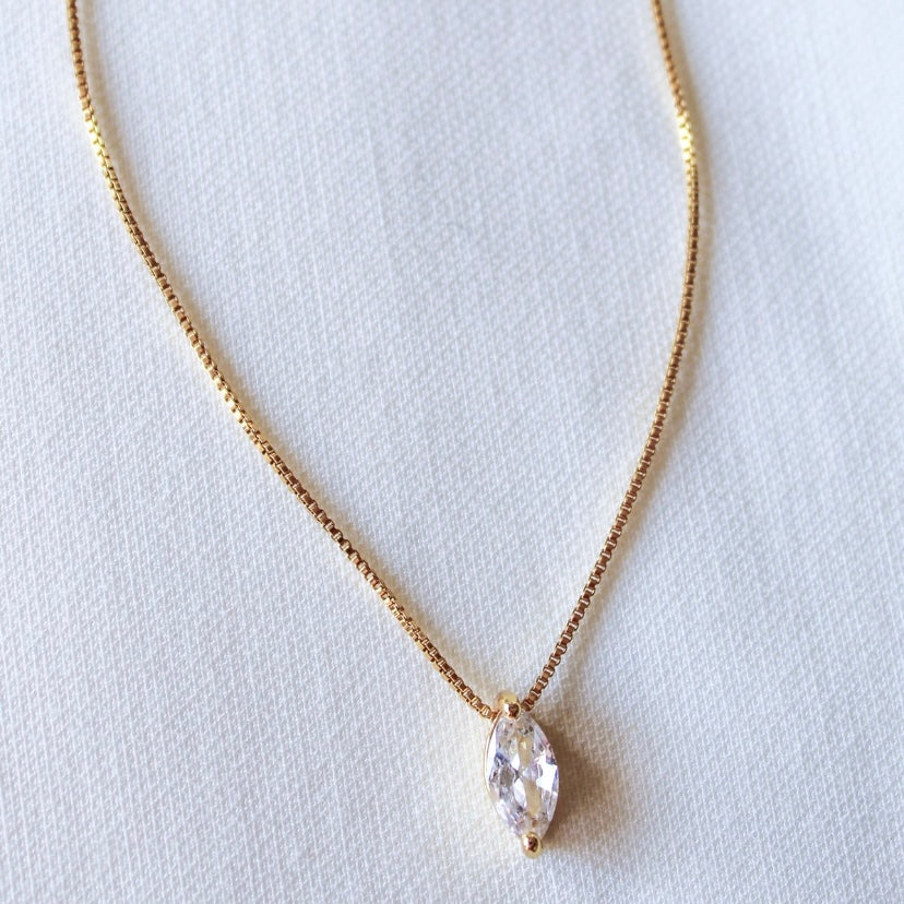 The Kinsey Designs Archives Marquise Slide Necklace features a sparkling cubic zirconia pendant, beautifully displayed on a white textured background.