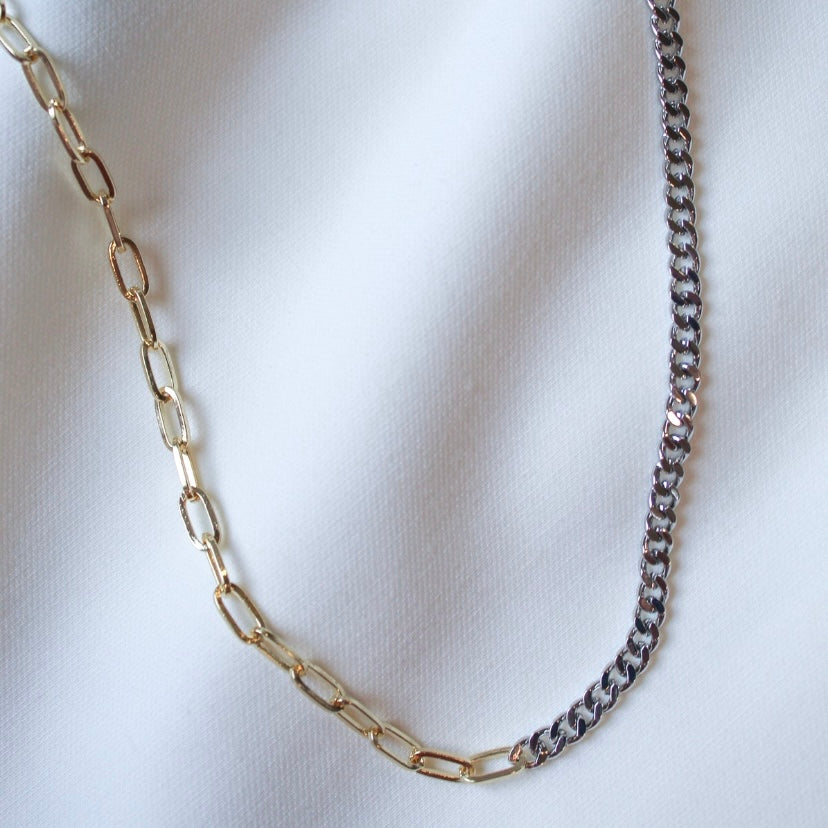 The Saxon Mixed chain by Kinsey Designs Archives features two-tone gold-filled and silver links. This 18" necklace is ideal for layering or wearing solo—shop it now in our sample sale, pictured on a white fabric background.