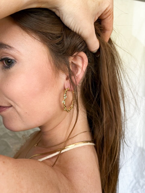 A woman holds her hair up, showcasing the Kinsey Designs Archives Reese Hoop, a gold filled textured earring with a 1.5" diameter.