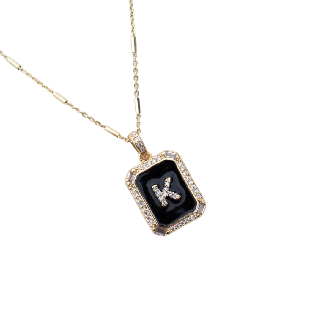 The Kinsey Designs Archives Initial Tile Necklace Ink Letter K features a gold chain with a rectangular black pendant, diamond border, and a diamond-studded letter "K".