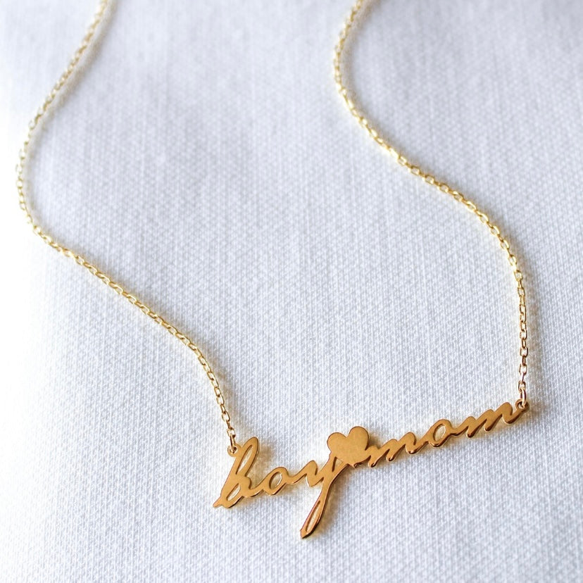 The Boy Mom Script Necklace by Kinsey Designs Archives features "boy mom" in cursive with a heart accent on a gold filled 16-inch chain, perfect for everyday wear.