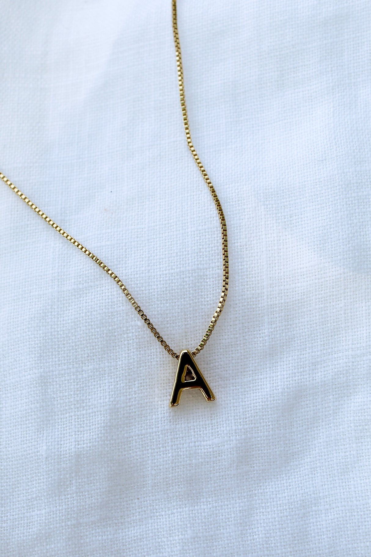 Kinsey Designs Collection Kinsey Slide Initial Necklace Letter A displayed on a white fabric background.