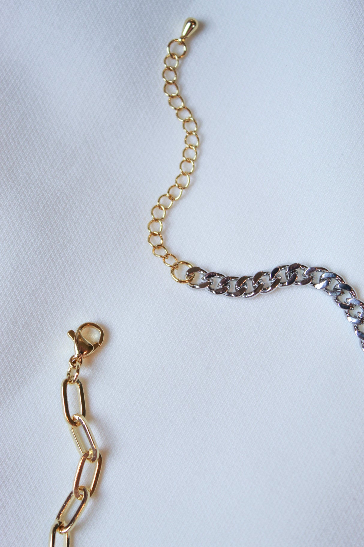 Saxon Mixed necklaces by Kinsey Designs Archives—gold-filled and silver 18" chains with clasps on white fabric—perfect for any sample sale.