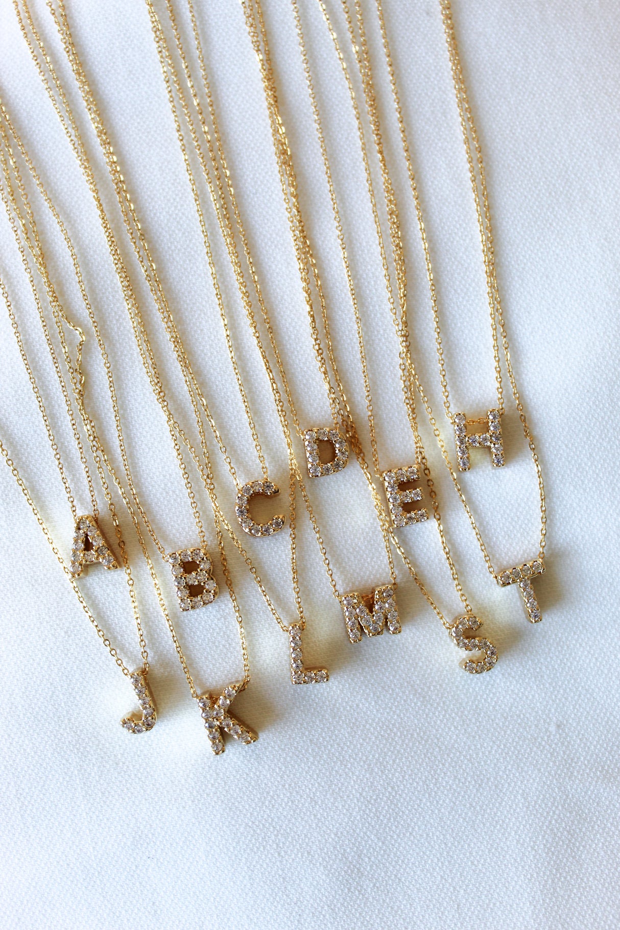 The Kinsey Designs Collection LUX Slide Initial Necklace Letter C is shown on a white fabric background.