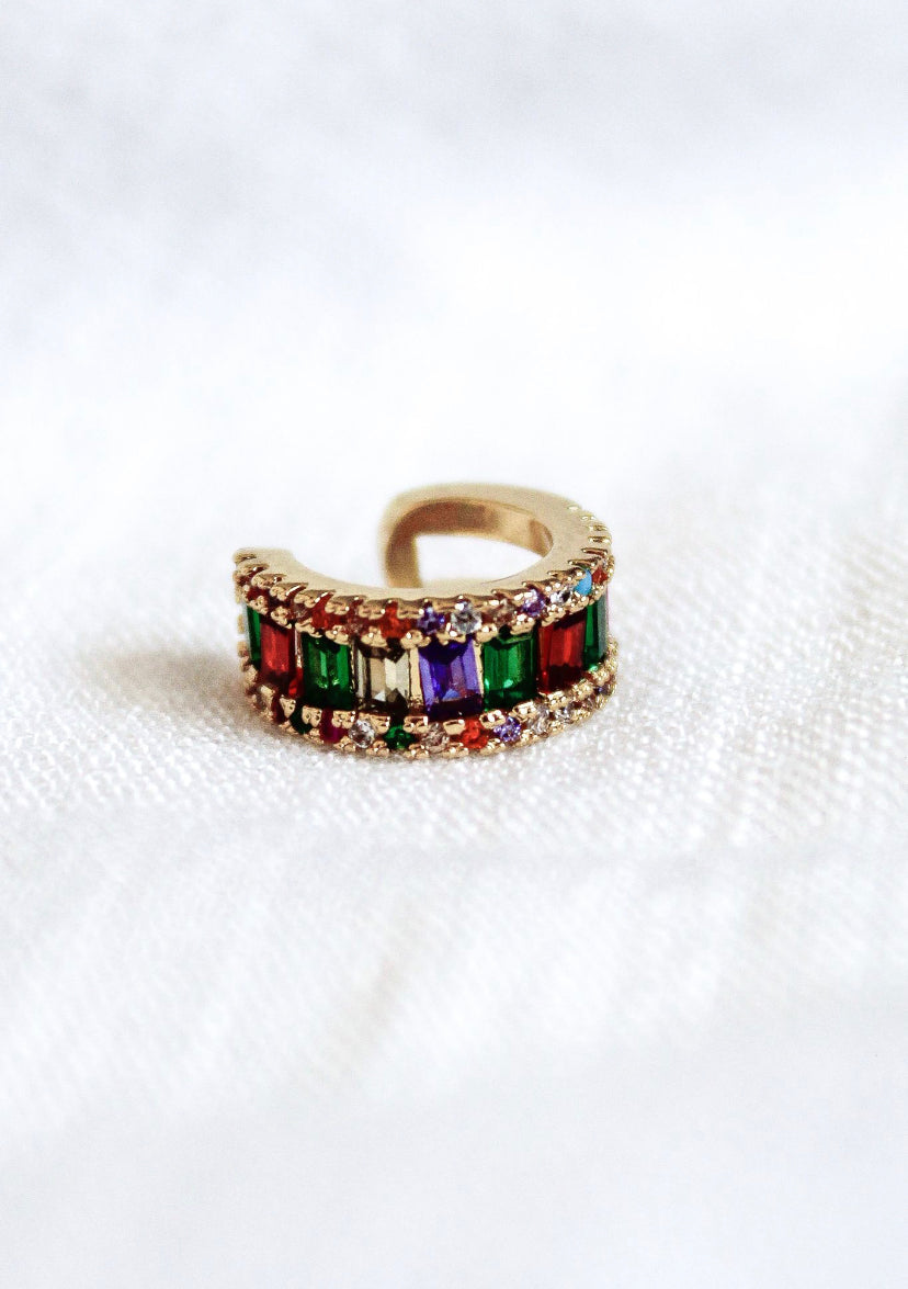 The Clementine Ear Cuff by Kinsey Designs Archives features colorful rectangular cubic zirconia set in gold fill, displayed on a white textured surface.