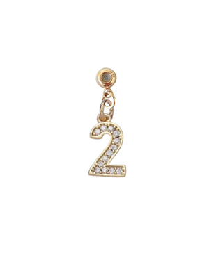 The Kinsey Designs Collection Numerical Grip Charm Number 2 features a gold charm shaped like the number 2, adorned with small rhinestones and displayed against a white background.