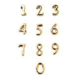 The Numerical Slide - Kinsey Charm Bar features gold-filled number charms from 0 to 9, arranged in three rows.