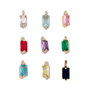 Nine rectangular gemstone charms in gold settings are arranged on a white background—ideal for designing your own Kinsey NP Adjustable Necklace by Kinsey Designs or layering with another piece.