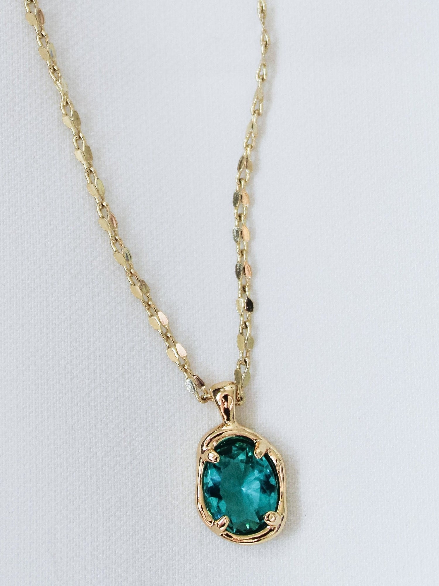 The Birdie Blue Necklace by Kinsey Designs Archives features an oval green gemstone pendant on an 18-inch gold filled chain, shown against a plain white background.