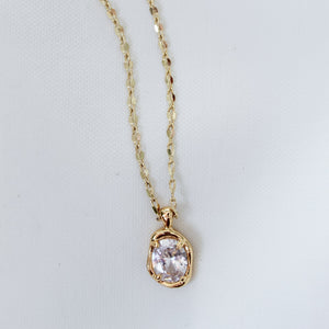 Kinsey Designs Birdie Necklace features a round, clear gemstone pendant on a delicate gold filled chain, shown against a white background.