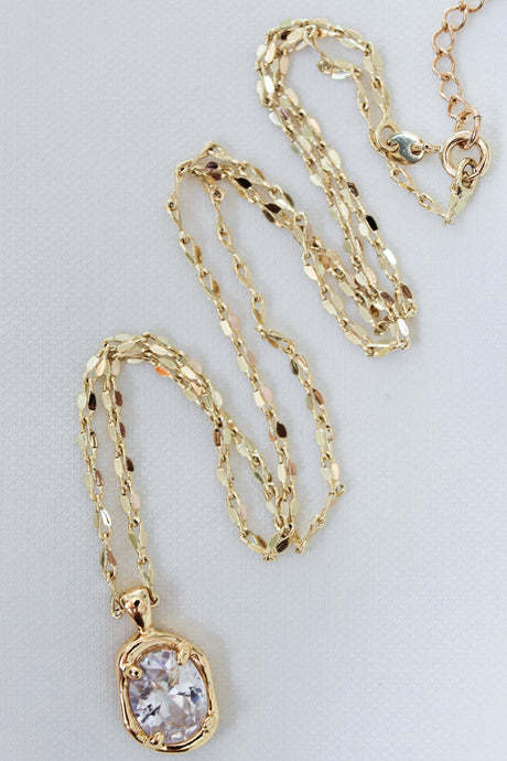 Kinsey Designs' Birdie Necklace features a clear cushion-cut CZ stone pendant on a gold-filled chain, shown against a white background.