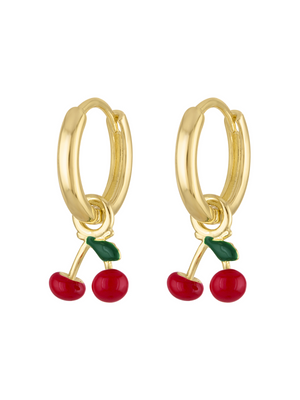 The Cherry Huggie Earring by Kinsey Designs features gold hoops adorned with small red cherry charms and delicate green leaves.