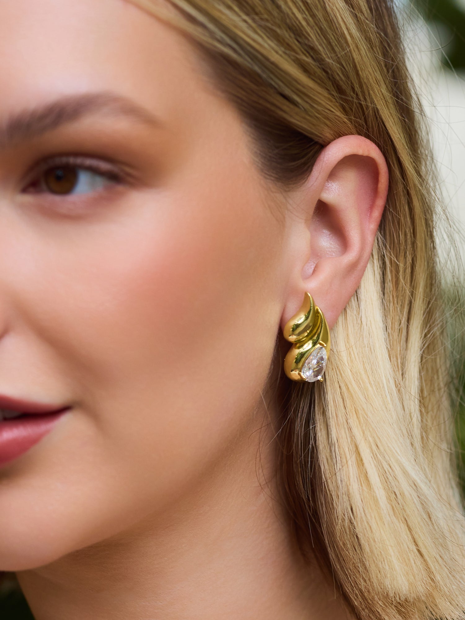 Close-up of a woman wearing the Kinsey Designs Archives Double Drop Stud—gold filled earrings featuring a teardrop gemstone, ideal for elevating your jewelry collection or finding at a sample sale.