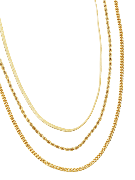 The Emile Layer Necklace by Kinsey Designs Archives features four distinct gold chains arranged in parallel on a white background, highlighting its elegant layered design.