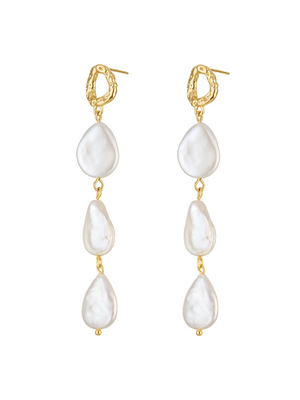 The Evie Pearl Drop Earring by Kinsey Designs showcases three irregular white pearls in a vertical gold hammered post, creating an elegant triple pearl drop look.