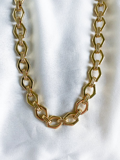 The Prague- Slight Flaw gold chain by Kinsey Designs Archives displayed on a white surface.