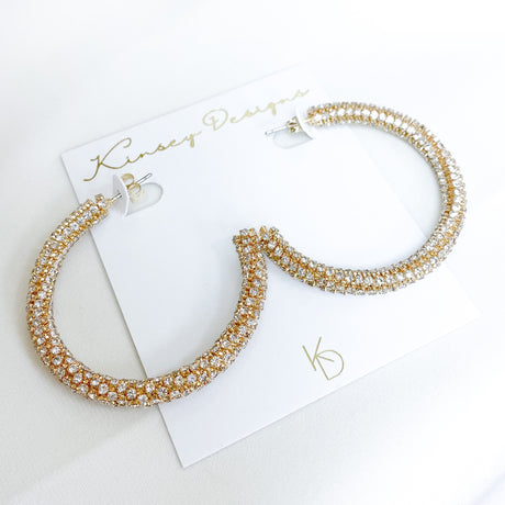 Large Marlowe Hoop earrings with rhinestones in gold filled and silver, displayed on a white Kinsey Designs Archives card.