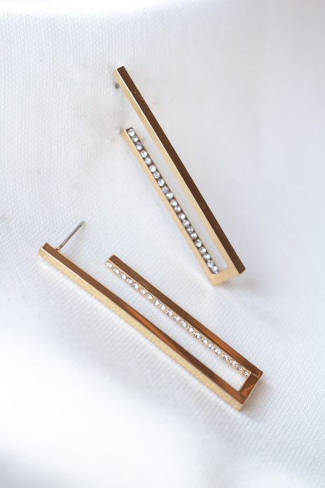 The Inside Job Hoop by Kinsey Designs Archives: rectangular gold-filled earrings with a row of cubic zirconia, showcased on white fabric. Enjoy elegant style at an exclusive sample sale price.