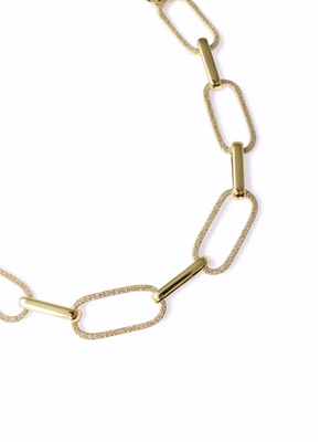 The Jameson Necklace by Kinsey Designs features alternating textured and smooth rectangular gold links, creating a striking statement piece.