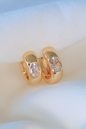 The Jack Huggie by Kinsey Designs, gold filled hoop earrings with oval gemstones, displayed on soft white fabric—ideal for those seeking unique sample sale jewelry.