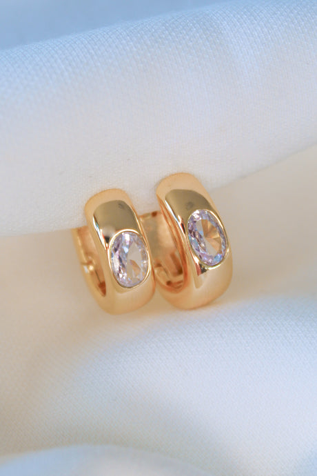 The Jack Huggie by Kinsey Designs, gold filled hoop earrings with oval gemstones, displayed on soft white fabric—ideal for those seeking unique sample sale jewelry.