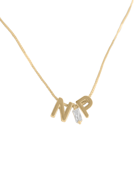The Kinsey NP Adjustable Necklace by Kinsey Designs features "N" and "P" letter charms and a small rectangular crystal pendant, offering an elegant touch—displayed on a white background.
