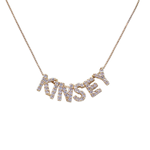 The LUX Letter Slide Charms by Kinsey Designs spell "KINSEY" and are featured as sparkling gold necklace charms on a white background.