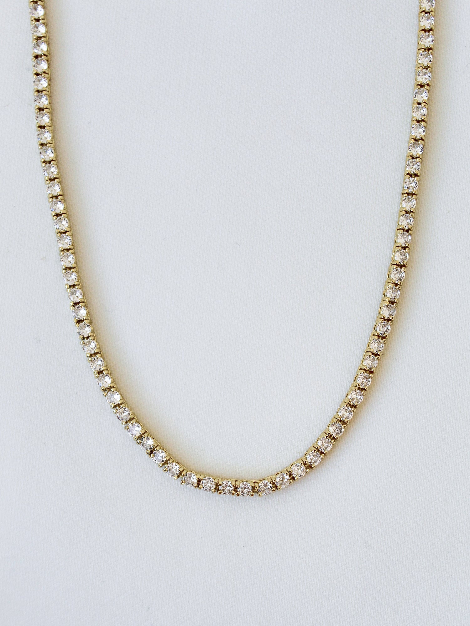 The Malia Tennis Necklace by Kinsey Designs Archives features round diamonds and a 15" gold filled chain, shown on a white background. Don’t miss your chance to own this classic piece at our exclusive sample sale.