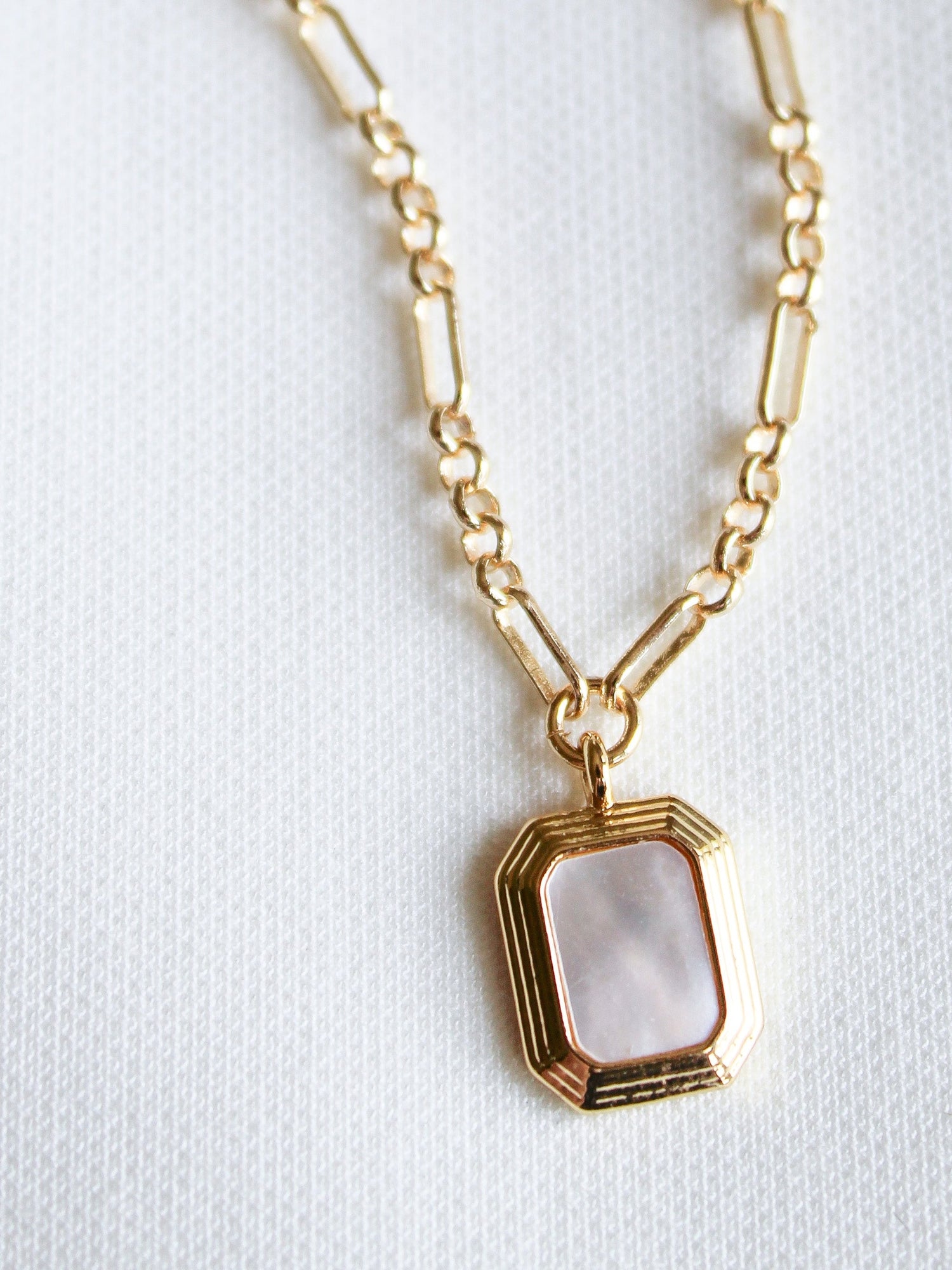 The Mirabelle Pendant Necklace by Kinsey Designs Archives features a rectangular mother-of-pearl pendant on a classic 20" gold filled chain, displayed against a white textured background.