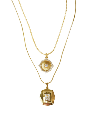 The Kinsey Designs Orion Detachable Necklace features two gold-filled chains, each with a unique pendant and clear gemstone accents. Wear together for a layered look or separately—each necklace is detachable for versatile styling.
