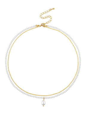 The Opaline Double Layer Necklace by Kinsey Designs features gold and pearl double strands, a single pearl pendant, and an adjustable clasp for the perfect fit.