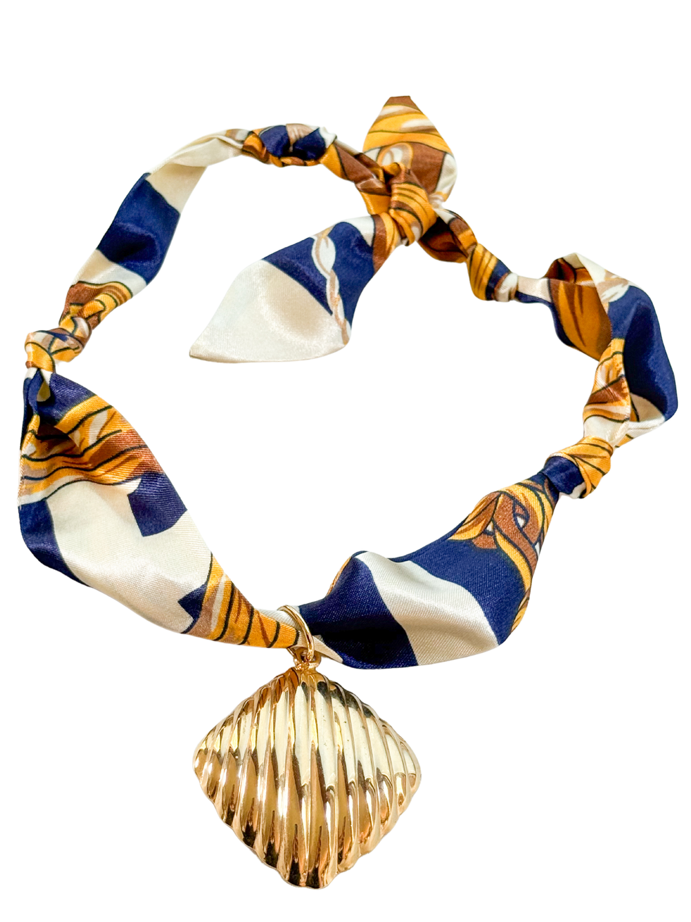 The Piacenza Scarf Necklace by Kinsey Designs features an adjustable silk scarf in blue, white, and gold, accented with a vintage-inspired gold seashell pendant for a perfect fit.