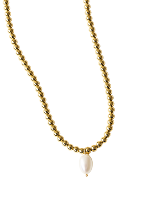 The Reed Necklace by Kinsey Designs features a single oval pearl pendant on a gold filled chain, creating an elegant look.