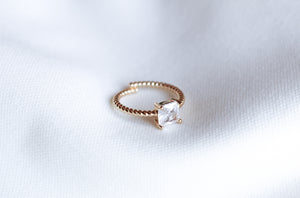The Rose Ring - Sale by Kinsey Designs Archives features a square-cut cubic zirconia, elegantly displayed on a white fabric background.