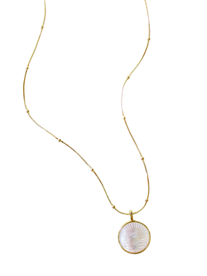 The Shiloh Pearl Necklace by Kinsey Designs Archives features a gold-filled chain with a round mother-of-pearl pendant carved with a face design on a white background.