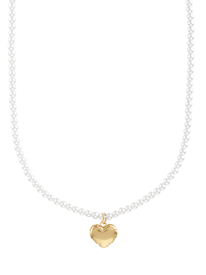 The Tilly Puff Heart Necklace by Kinsey Designs features a gold heart pendant on a delicate strand of small white pearls.