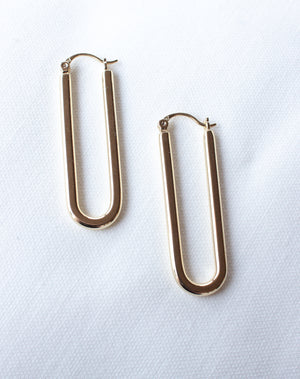 The Tate Hoop by Kinsey Designs Archives—gold filled oval hoop earrings—displayed on a white textured fabric background. Final sale.